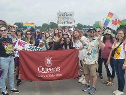 Queen's Faculty of Education Banner surrounded by GSA members