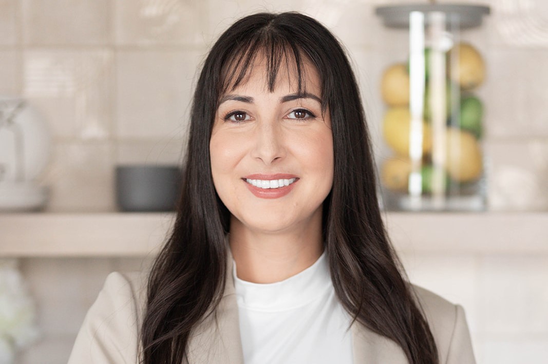 A photo of a woman standing in a kitchen